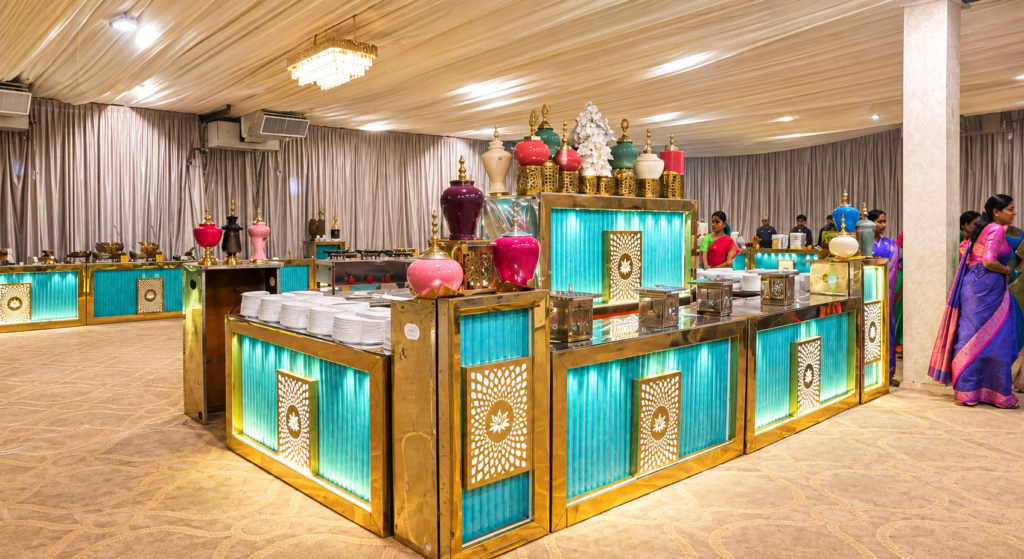 NS Convention dining hall with teal-lit buffet counters and floral centrepieces